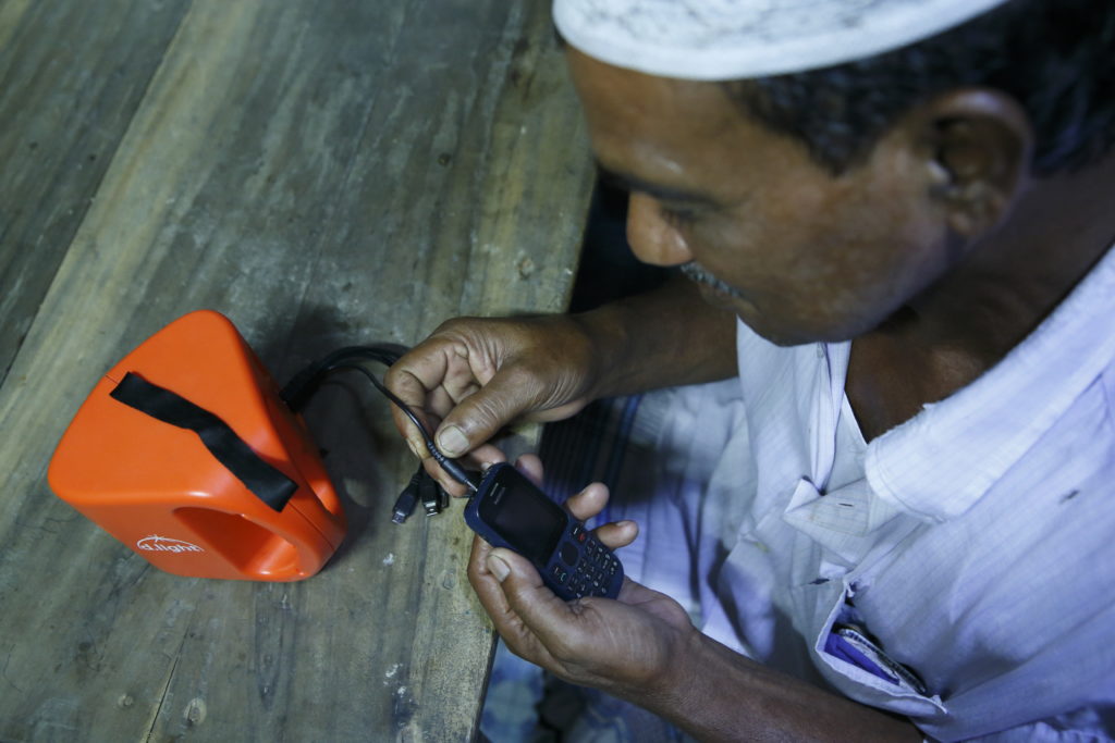 man-in-bangladesh-charging-phone
