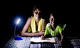 Children on the outskirts of Dakar use a solar-powered reading light to do their homework © Bruno Demeocq/Lighting Africa