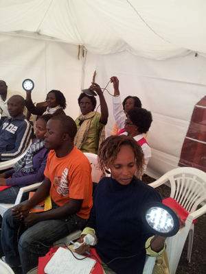 The consumer education team gets a first-hand feel of one of the few multi-room solar lighting products available on the Kenyan market in preparation of a road show © Lighting Africa