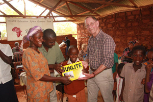 A child is presented with a Sunlite lamp in a bid to improve learning outcomes © HEART