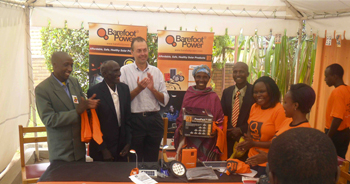 Barefoot presents its 5W solar home lighting system to the parents of Uganda's gold medalist Stephen Kiprotich Â© Barefoot Power