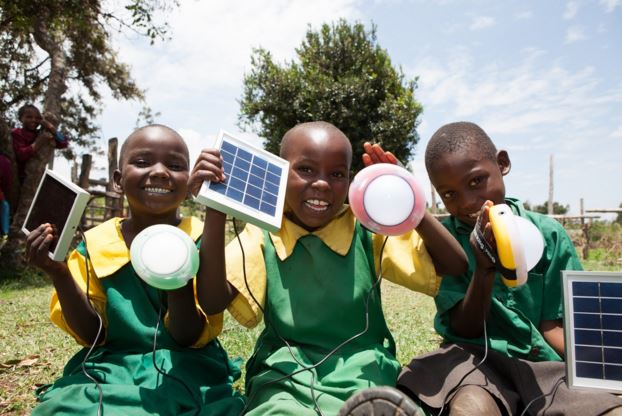 School children show off solar lanterns in Africa