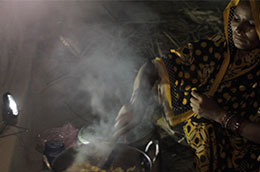 A woman in India prepares an evening meal for her family lighting up her kitchen with a solar lantern © Lighting Asia - India
